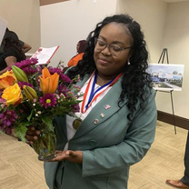Princess Holmes holding a bouquet of flowers